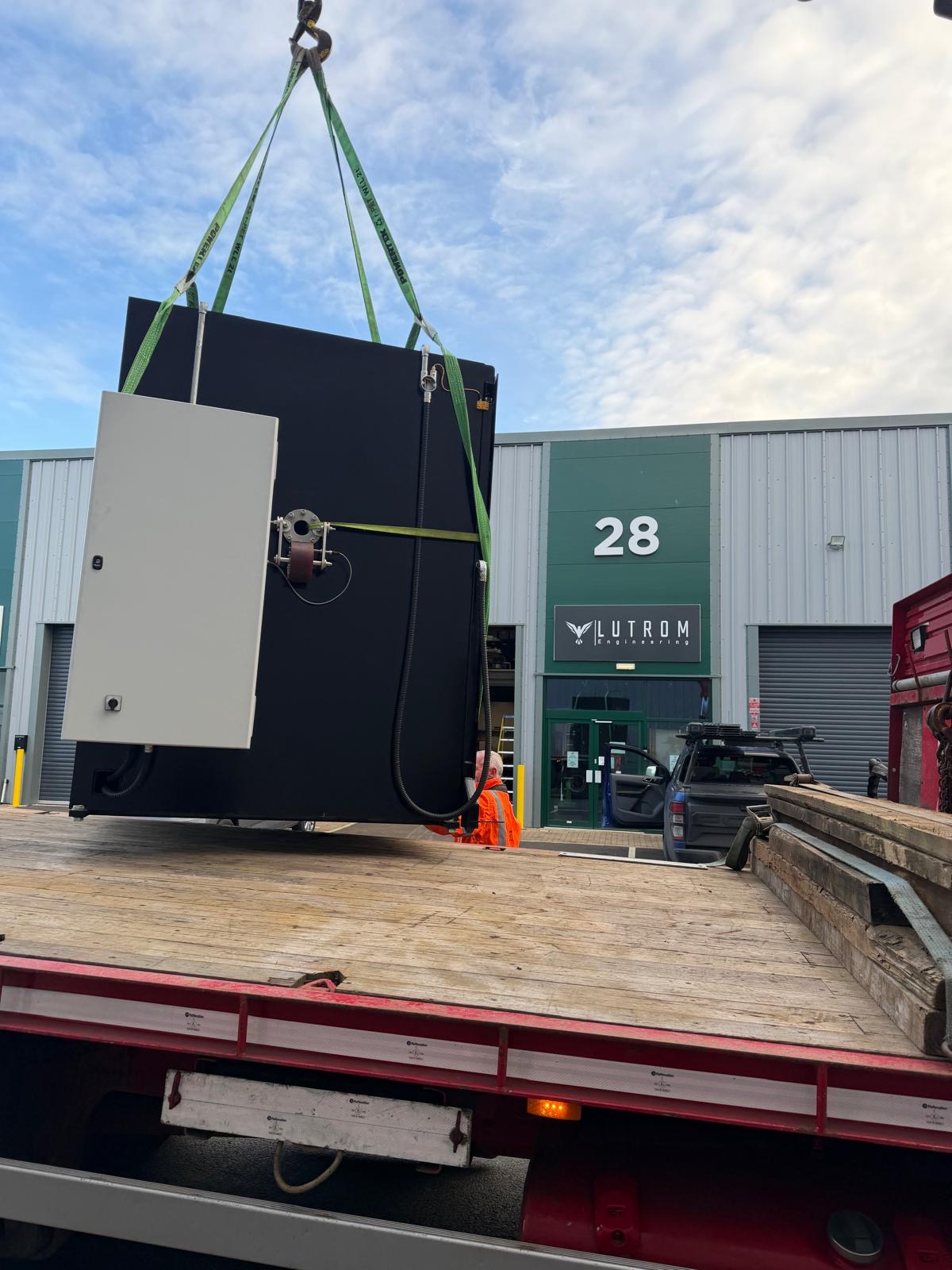 Lutrom Engineering HQ at Unit 28, Winnington — completed tangential taping machine being lifted onto a flatbed for delivery to the cable manufacturer